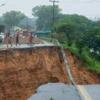 People look at a damaged road in Blantyre, Malawi, on March 14, 2023. (Photo: Joseph Mizere/Xinhua via Getty Images)